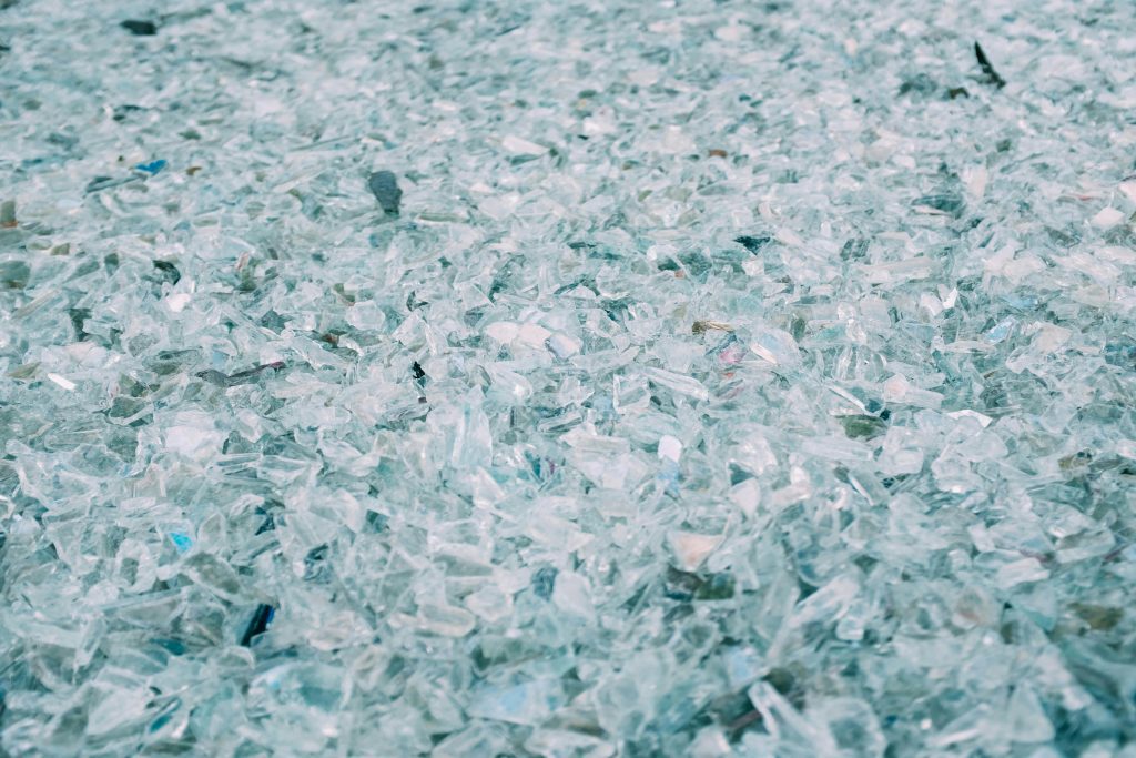 High detail close-up of shattered and scattered turquoise glass pieces with a soft focus.