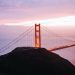 Stunning aerial view of the Golden Gate Bridge at sunset with vibrant sky in San Francisco, California.